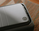 Close-up view of the front pocket on the expandable carry-on pro in storm grey.